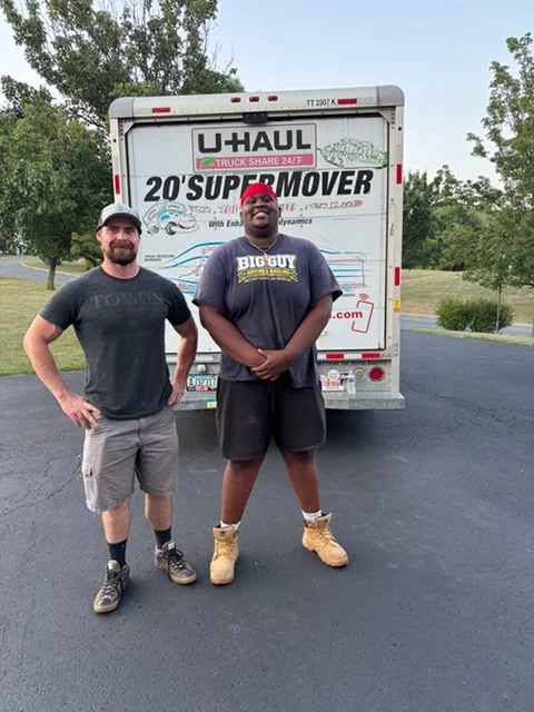 Big Guy Moving crew in front of a 20-foot truck