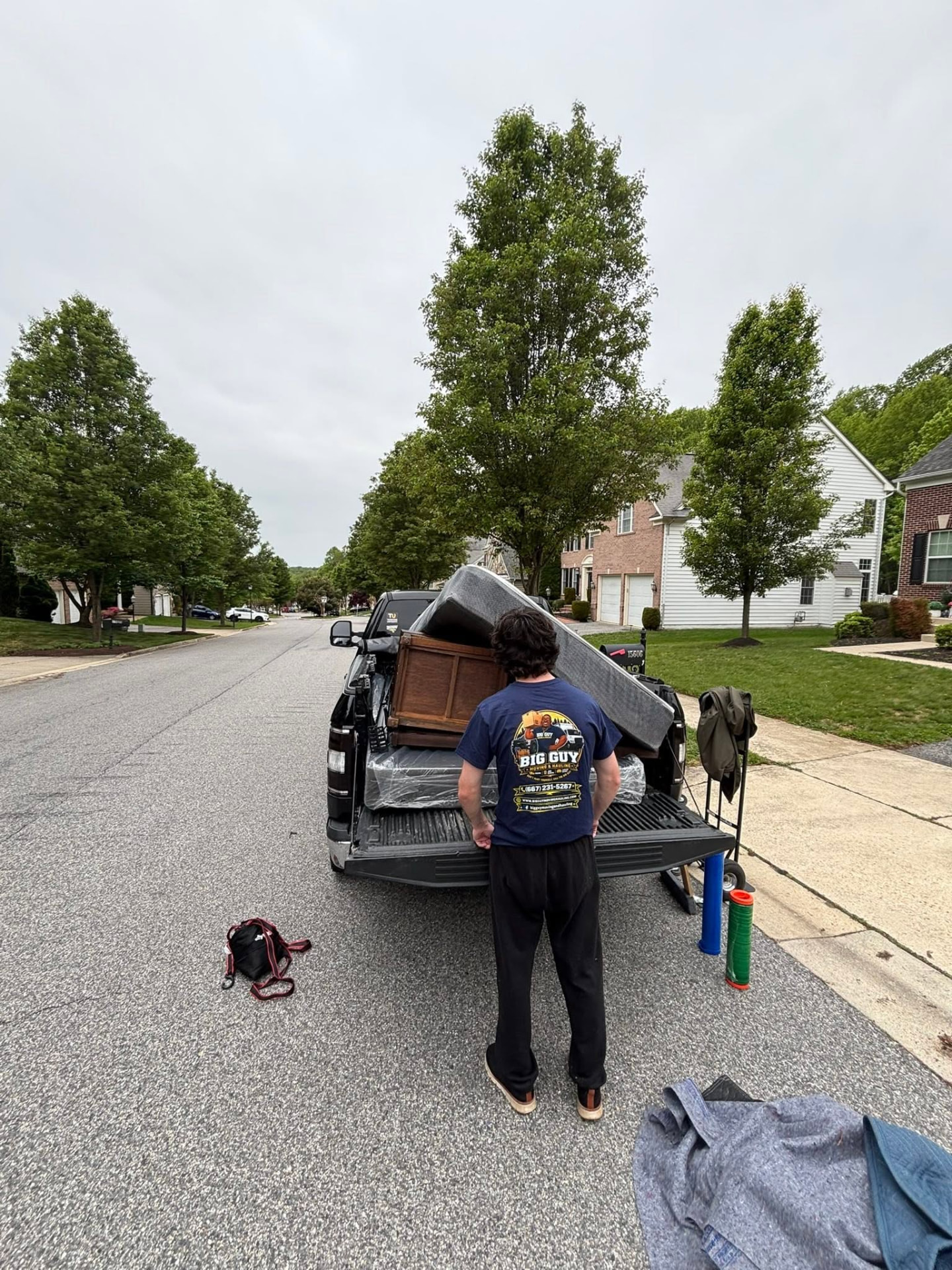 Mattress and dresser loaded curbside on a residential street