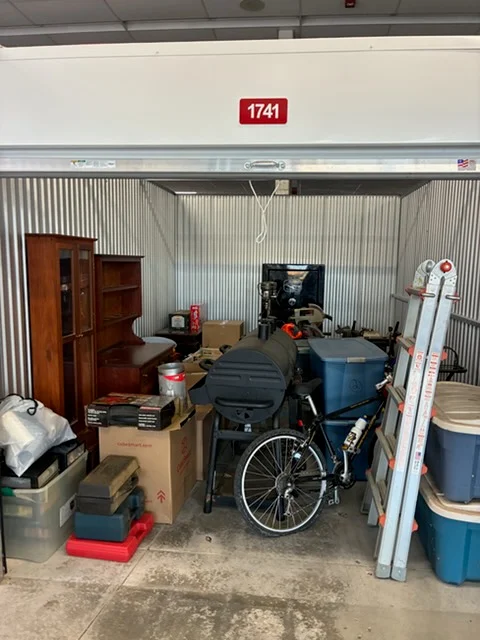 A packed storage unit before a Big Guy Moving cleanout