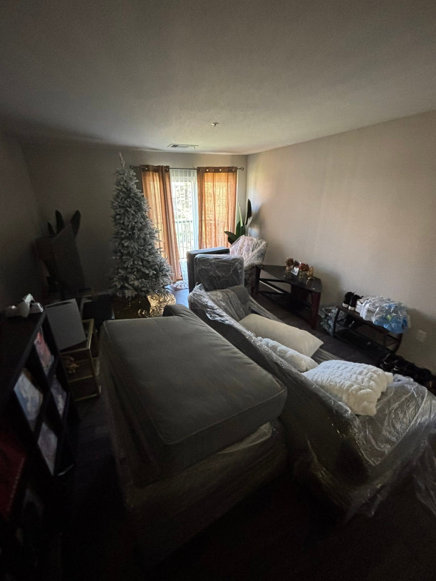 Living room furniture shrink-wrapped and staged for a Carroll County move