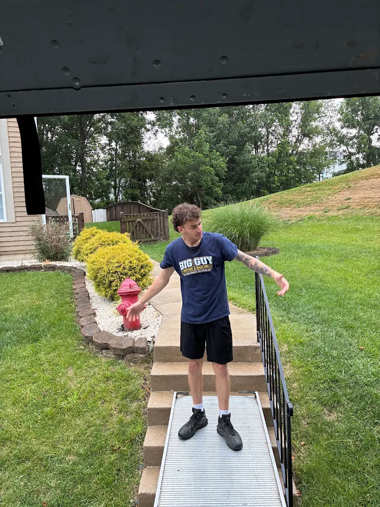Crew member setting an aluminum ramp over porch steps for a move