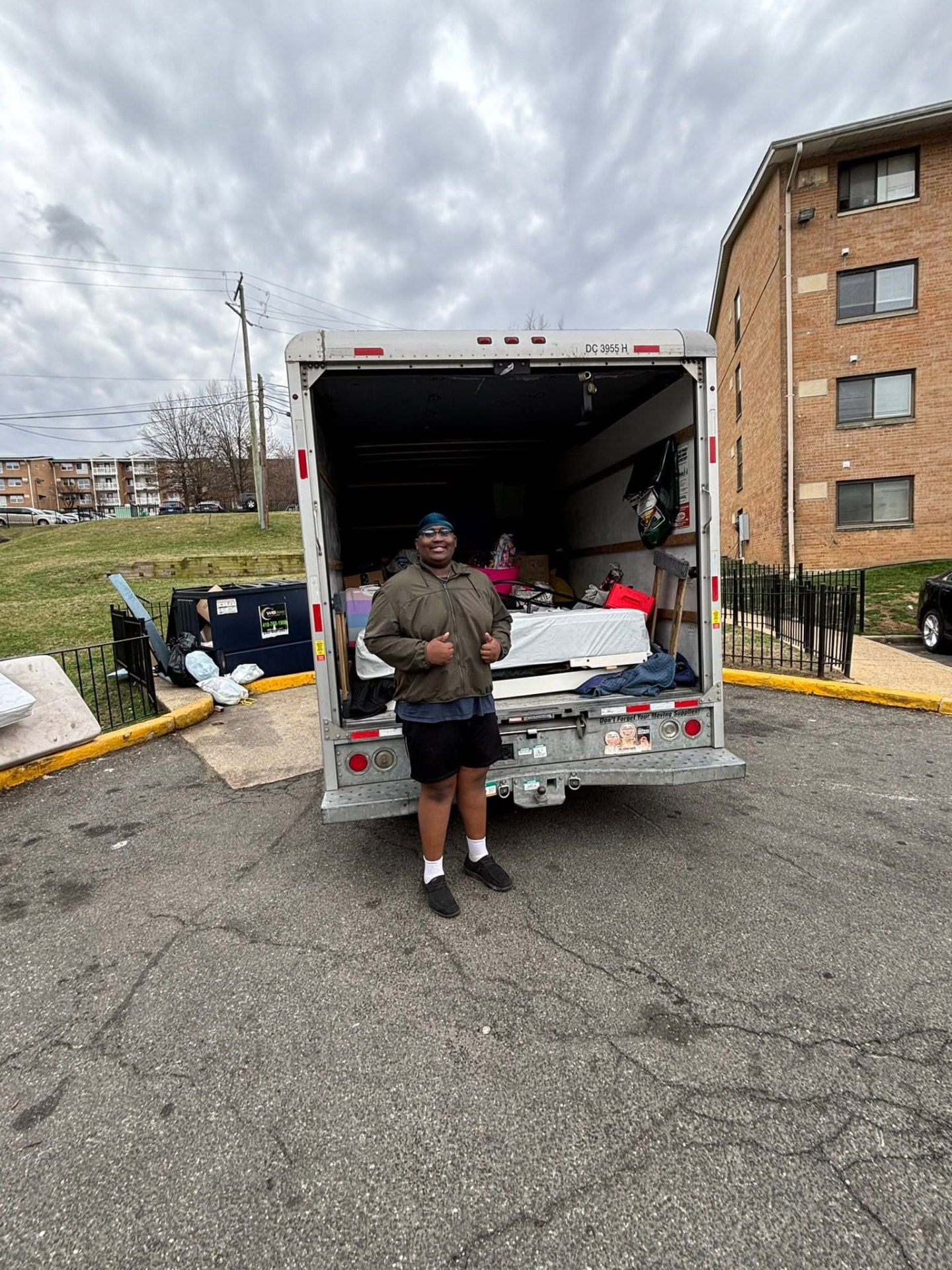 Big Guy Moving team member at the back of a loaded apartment move truck
