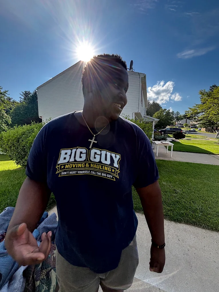 Aaron in his Big Guy Moving & Hauling shirt on a Westminster driveway