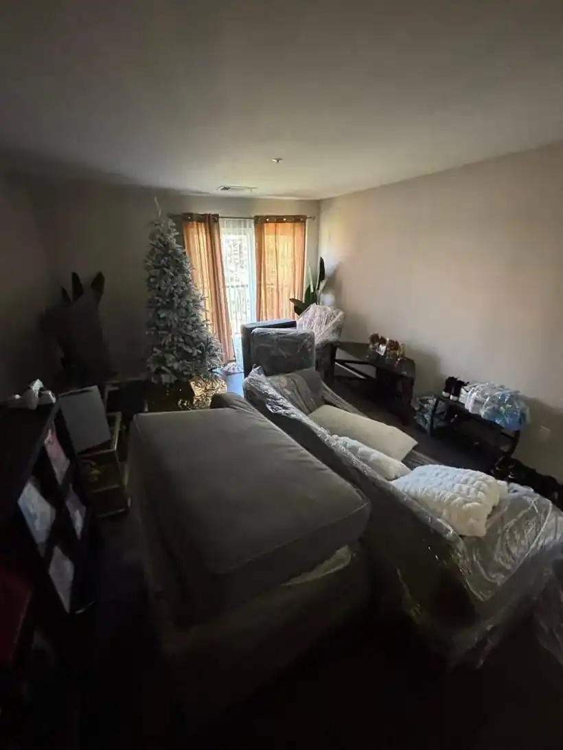 Living room furniture shrink-wrapped and staged for a Carroll County move