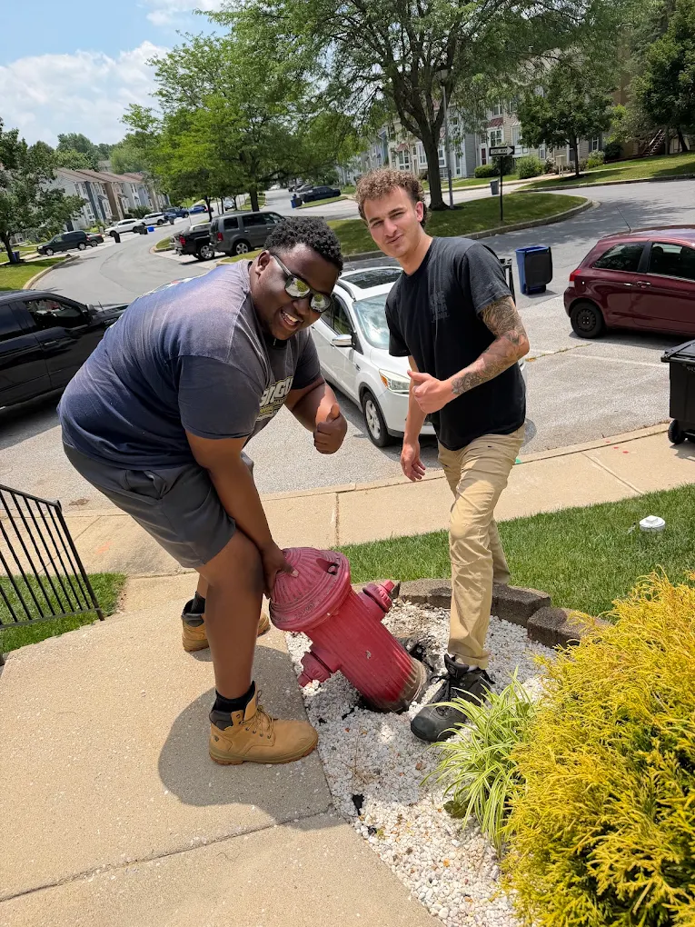 Big Guy Moving crew joking around a fire hydrant between apartment loads